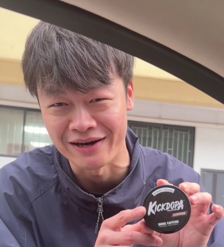 Tony from LC Sign holding a tin of KickDopa coffee caffeine pouches